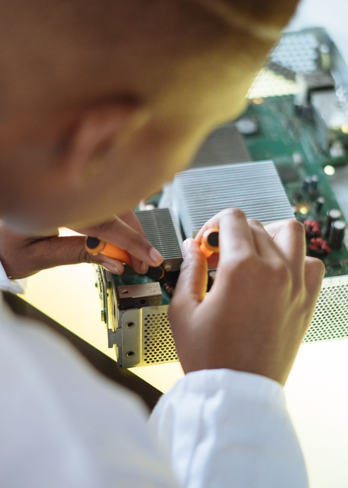 Crafting Captivating Headlines: Your awesome post title goes here Crop of ethnic system administrator in uniform using screwdrivers and checking motherboard on electronic equipment during work in repair department