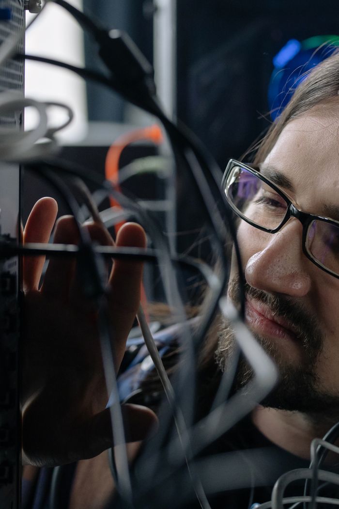 Mastering the First Impression: Your intriguing post title goes here Professional IT specialist handling network cables in a server room.